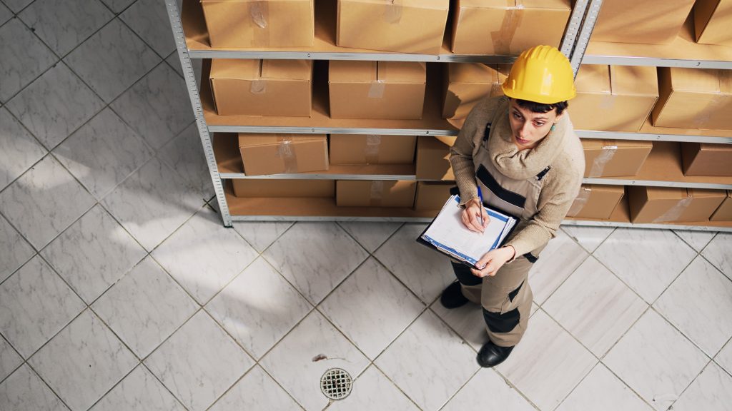 Optimize Your Amazon Sales with FBA Prep Services stockroom manager examining list of goods on shelves